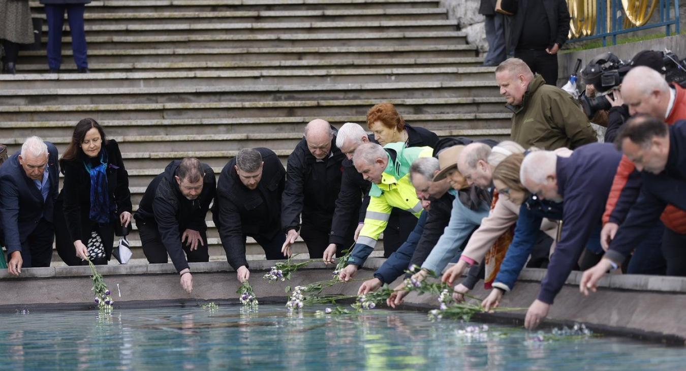workers memorial day laying flowers at pool
